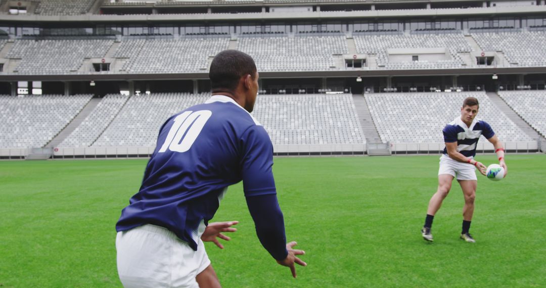 Professional Rugby Players Practicing Passing At Empty Stadium - Free Images, Stock Photos and Pictures on Pikwizard.com