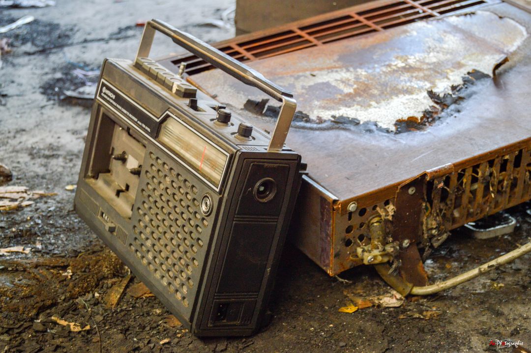 Vintage Rusty Portable Radio on Weathered Surface in Abandoned Building - Free Images, Stock Photos and Pictures on Pikwizard.com