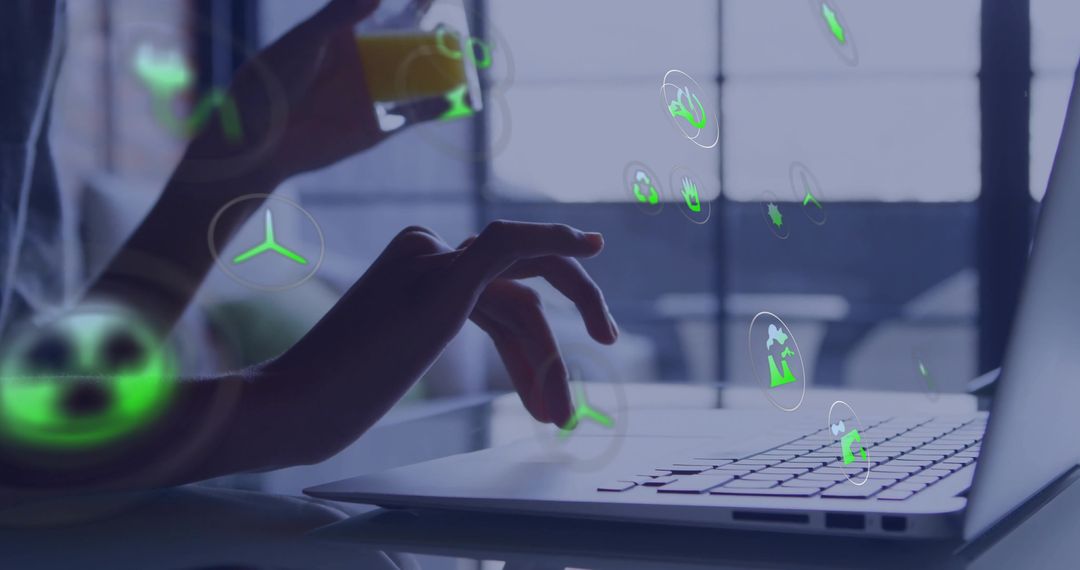 Hands typing on laptop with green holographic sustainability icons, remote work concept