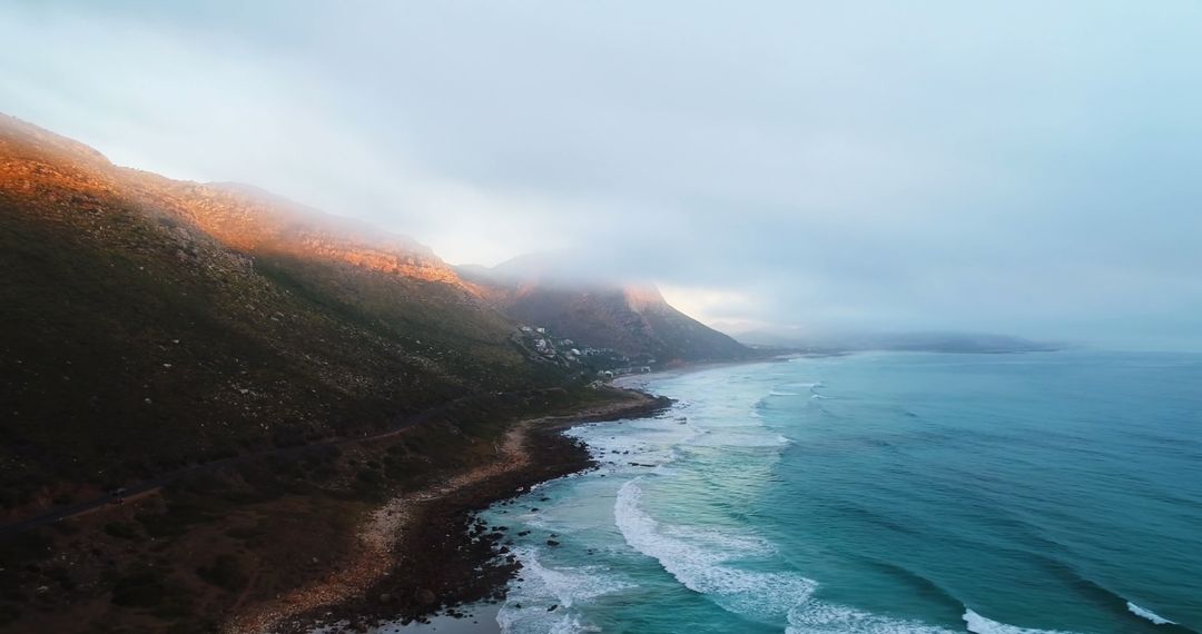 Serene Coastal and Mountain Landscape at Dawn or Dusk