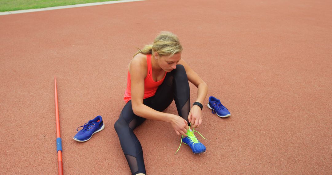 Female Athlete Preparing for Javelin on Track Field