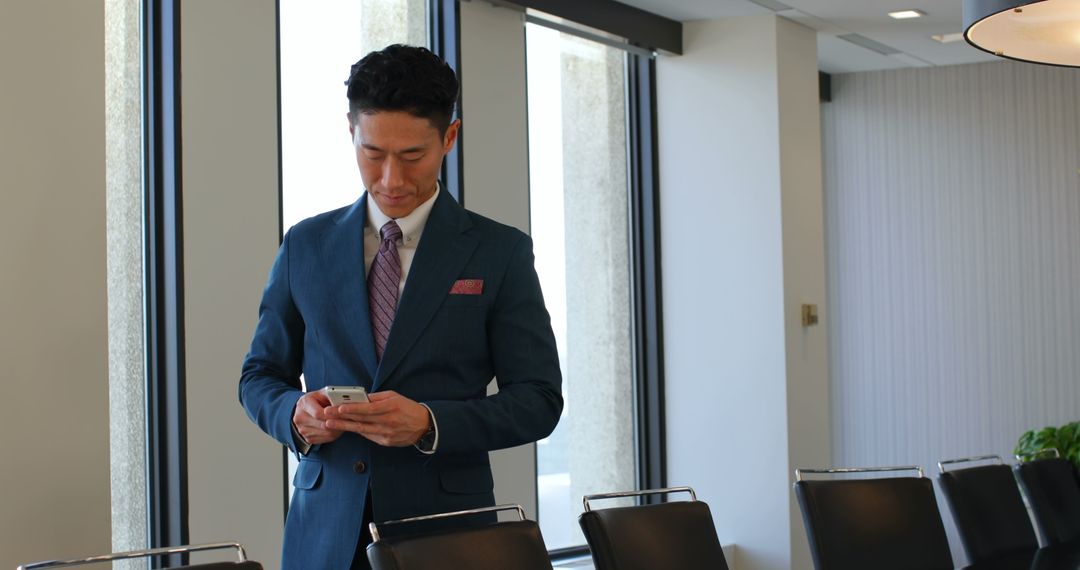 Business Executive Using Smartphone in Modern Office Environment