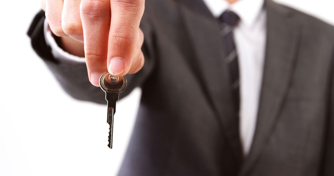 Businessman Holding Key, Offering Security and Opportunities - Free Images, Stock Photos and Pictures on Pikwizard.com