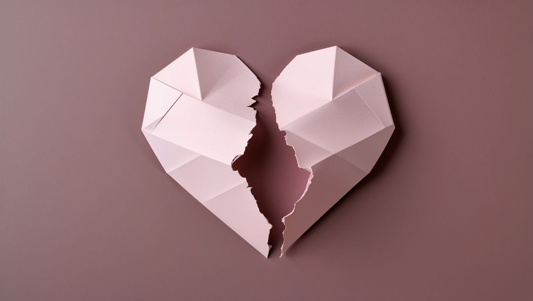 Origami Paper Heart Broken in Two on Mauve Background