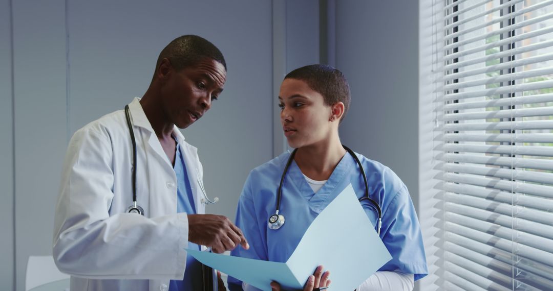 Medical Professionals Discussing Patient Records in Hospital - Free Images, Stock Photos and Pictures on Pikwizard.com