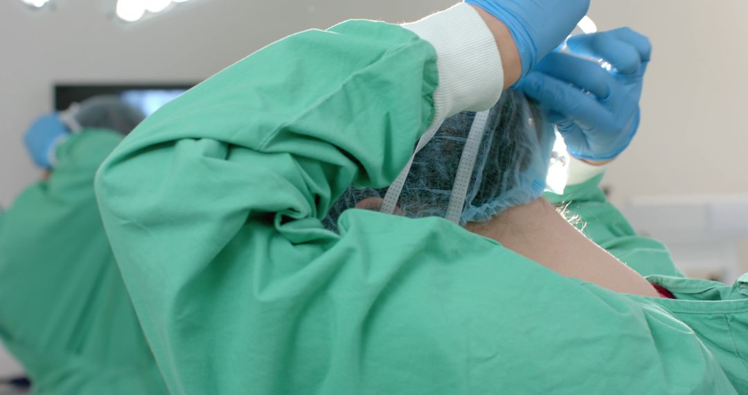 Surgeon Preparing for Surgery in Green Scrubs and Gloves - Free Images, Stock Photos and Pictures on Pikwizard.com