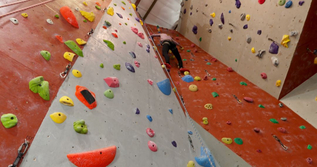 Determined Woman Embracing Challenge on Indoor Climbing Wall - Free Images, Stock Photos and Pictures on Pikwizard.com