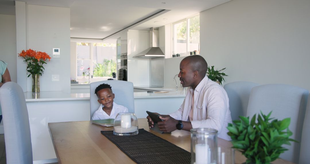 Smiling Father and Son Enjoy Breakfast in Modern Kitchen Setting