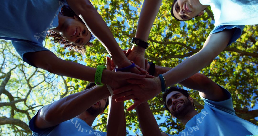 Group of Diverse Volunteers Stacking Hands Outdoors - Free Images, Stock Photos and Pictures on Pikwizard.com