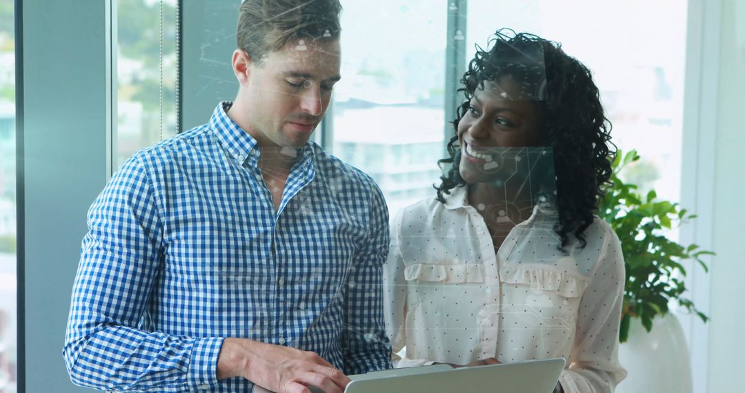 Colleagues Discuss Digital Business Strategy Near Office Window