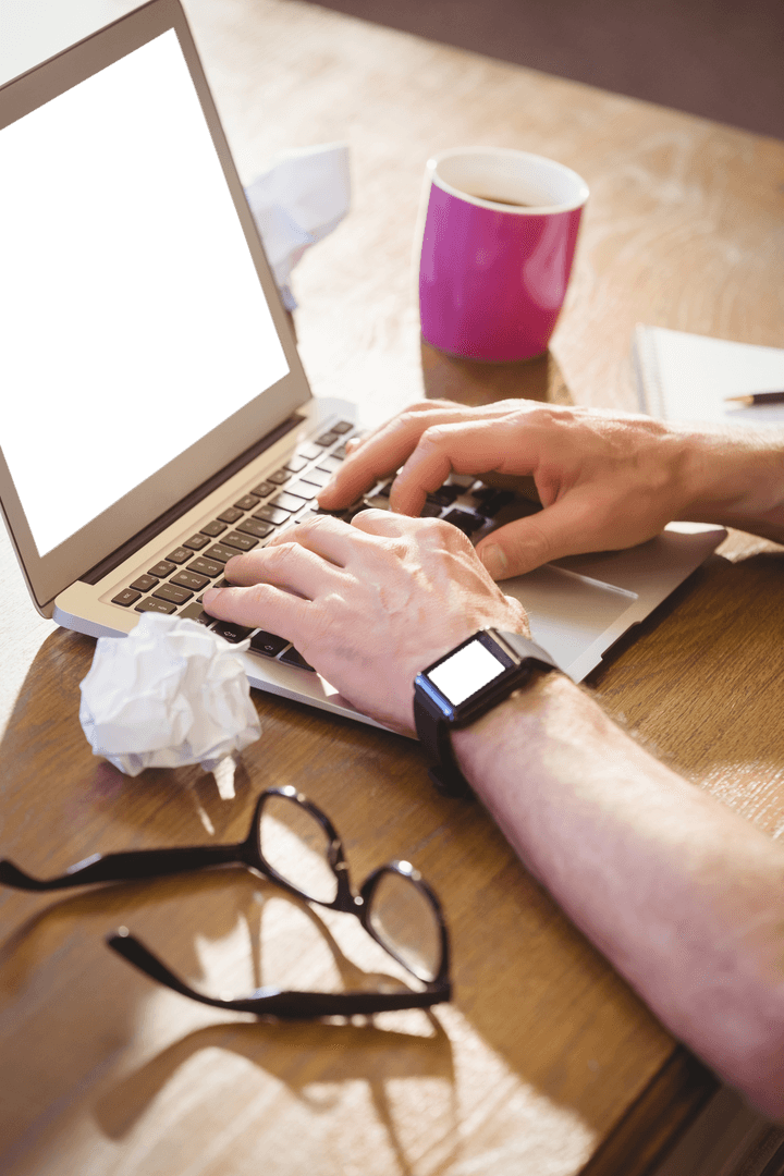 Transparent View of Hands Typing on Laptop with Coffee Cup