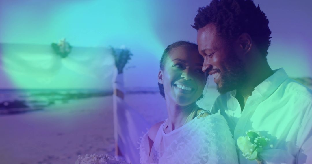 Smiling Couple Embracing on Beachfront Wedding Day Celebration