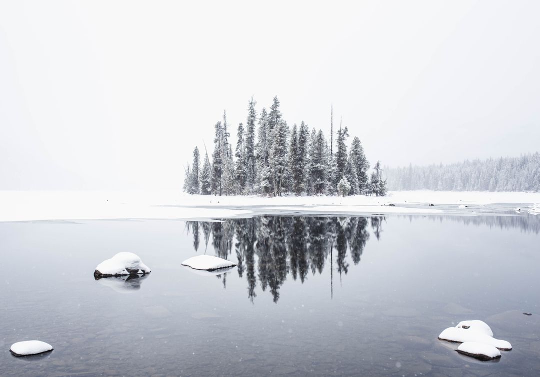 Serene Winter Landscape with Snow Covered Island in Reflective Lake - Free Images, Stock Photos and Pictures on Pikwizard.com