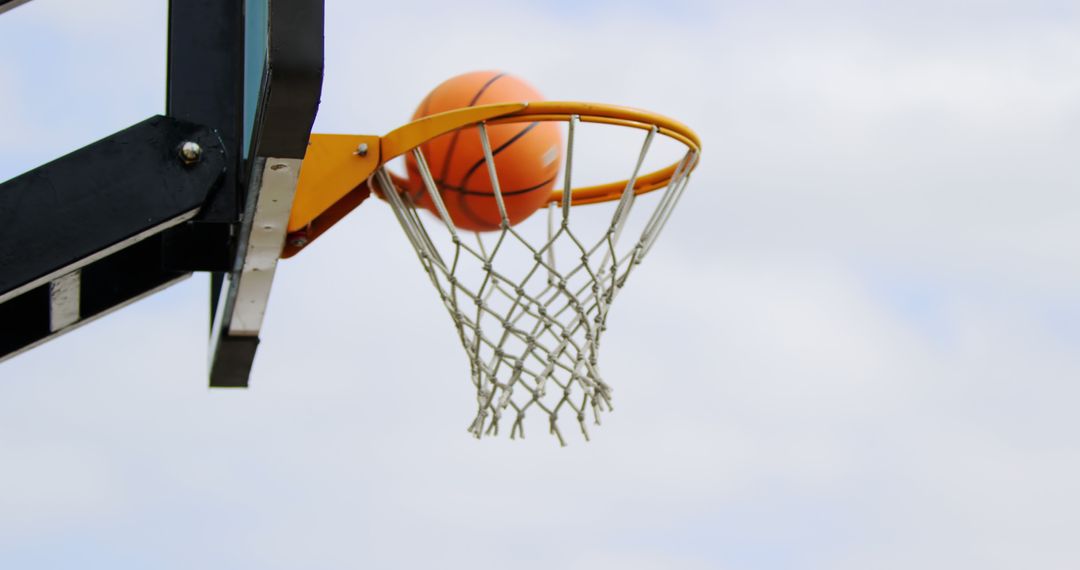 Basketball Going Through Net in Outdoor Game