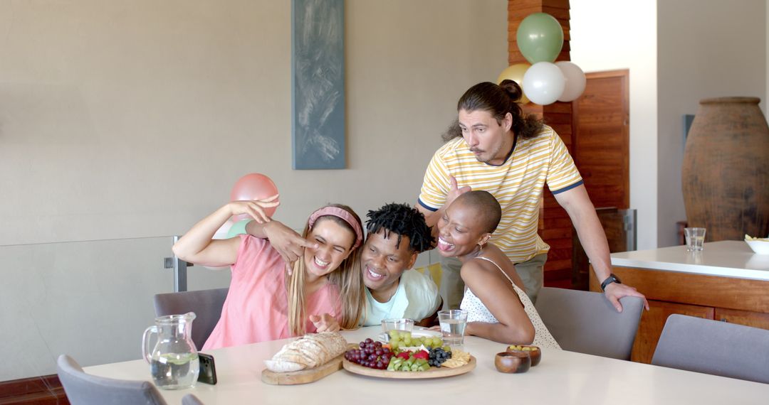 Diverse Friends Sharing Laughter and a Meal While Taking Selfie