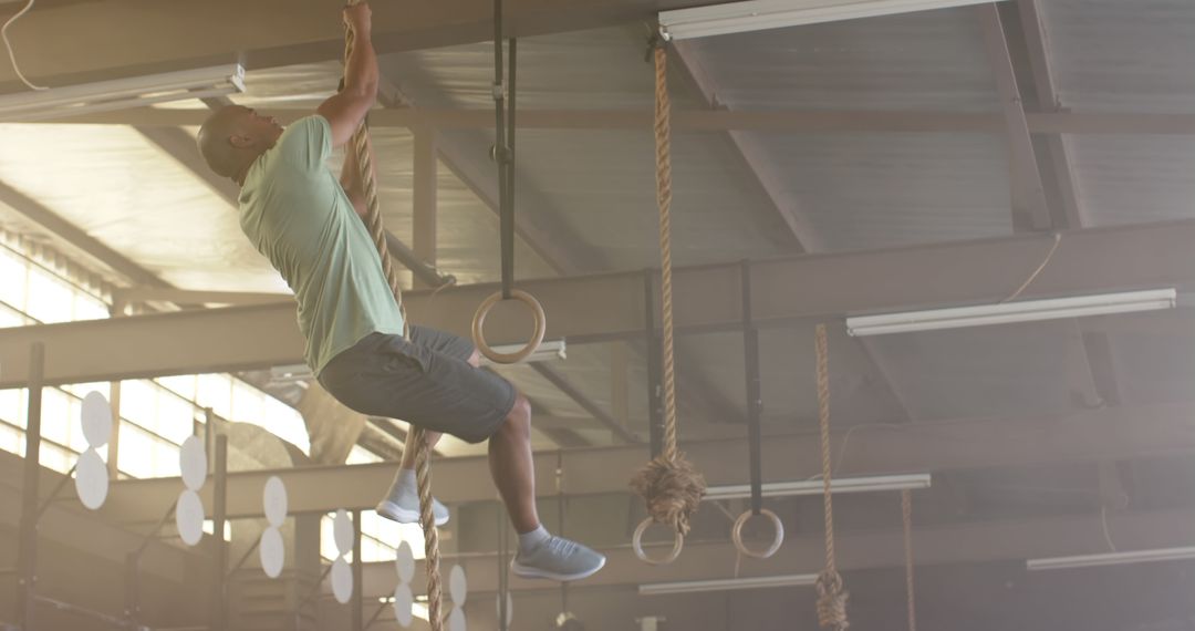 Man Climbing Rope in Gym for Strength Training - Free Images, Stock Photos and Pictures on Pikwizard.com