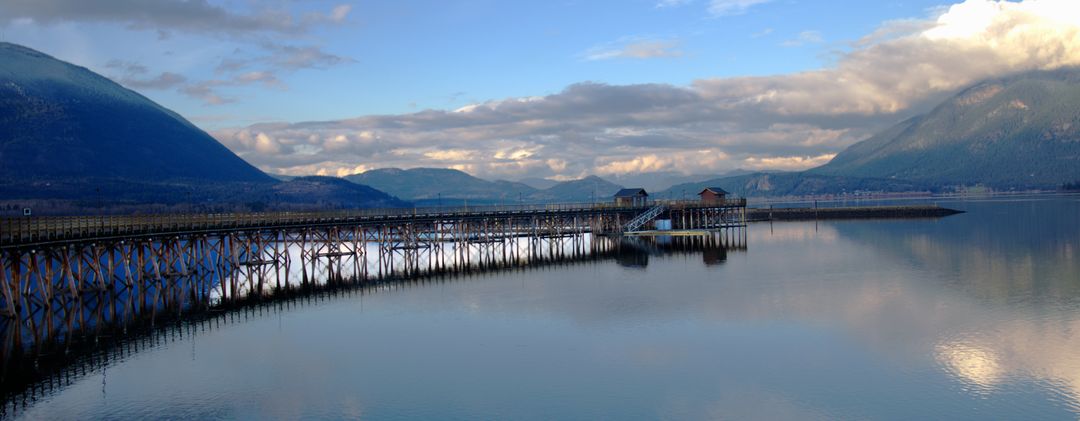 Scenic Lake Landscape with Wooden Pier and Hills in Background - Free Images, Stock Photos and Pictures on Pikwizard.com