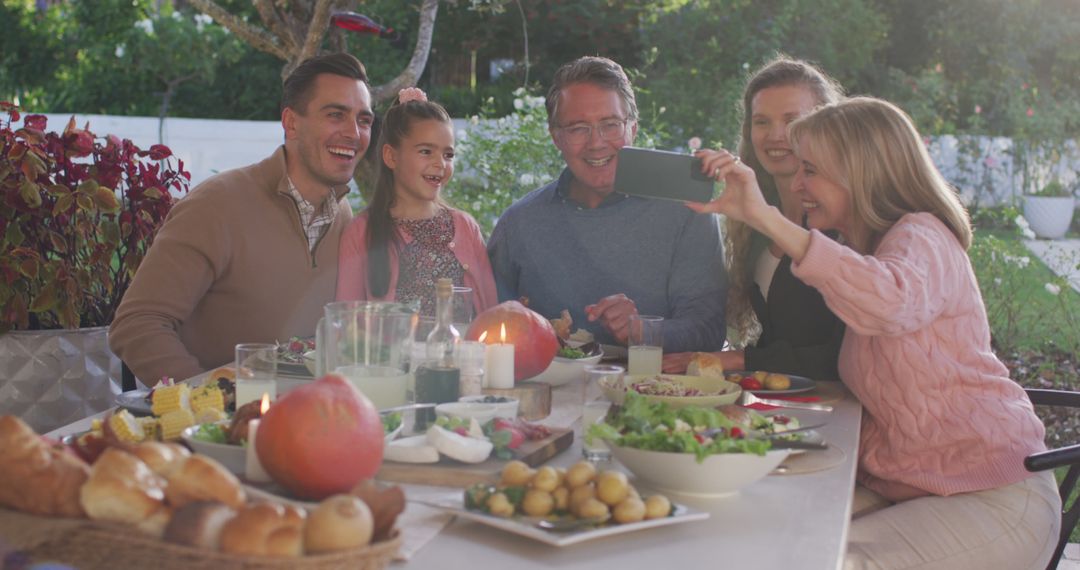 Image of happy caucasian parents, daughter and grandparents taking selfie at outdoor dinner table - Free Images, Stock Photos and Pictures on Pikwizard.com