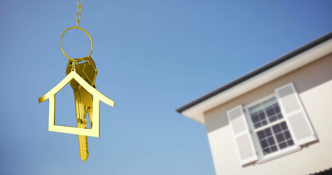 Golden House Keys Hanging Against Clear Blue Sky with Home - Free Images, Stock Photos and Pictures on Pikwizard.com