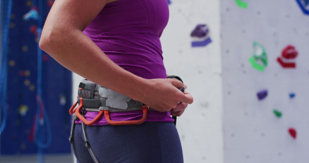 Woman Preparing Climbing Gear in Indoor Climbing Gym - Free Images, Stock Photos and Pictures on Pikwizard.com