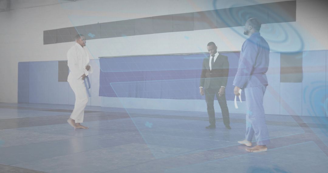 Martial arts instructor guiding whitebelt student during belt test while referee observing