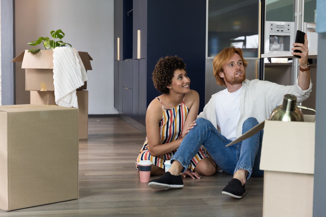 Happy Couple Taking Selfie While Moving into New Home