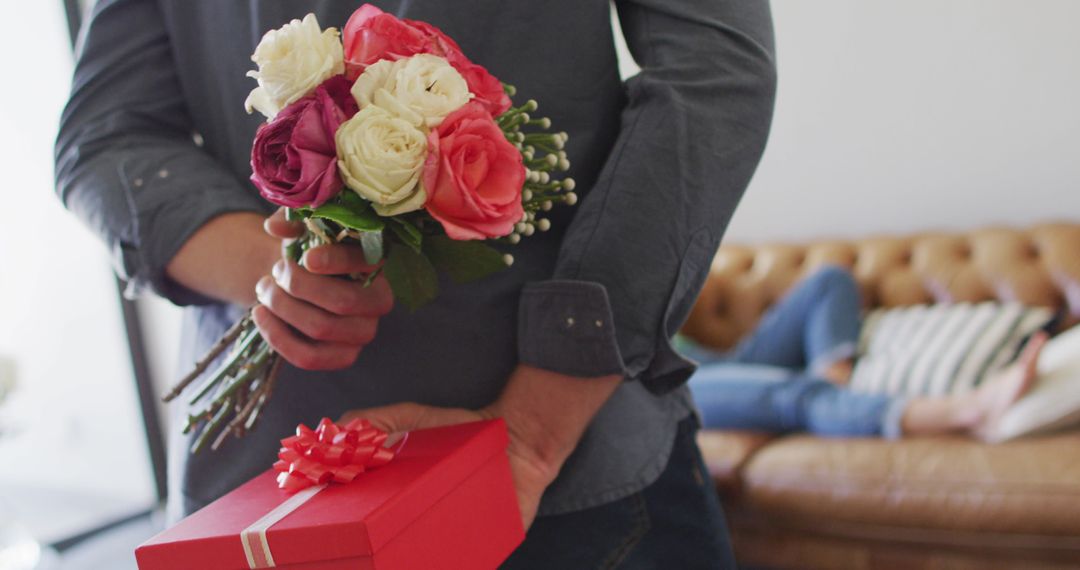 Man Surprising Partner with Flowers and Gift at Home