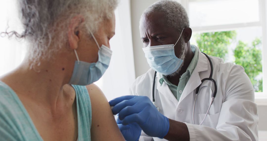 Doctor Administering Vaccine to Elderly Patient in Medical Clinic - Free Images, Stock Photos and Pictures on Pikwizard.com