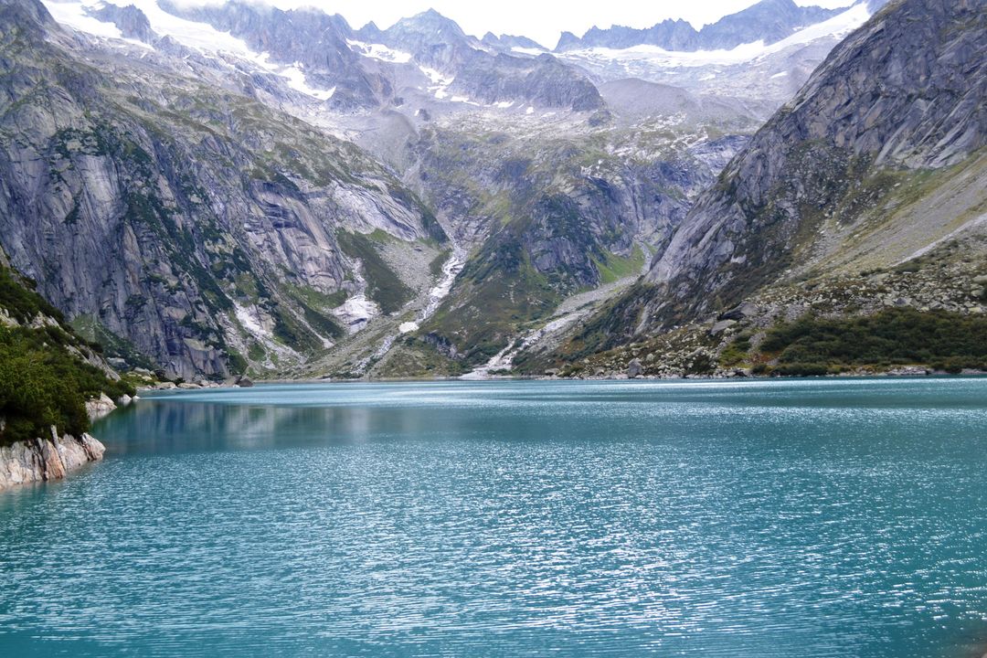 Pristine Mountain Lake with Rocky Hills and Snowy Peaks - Free Images, Stock Photos and Pictures on Pikwizard.com