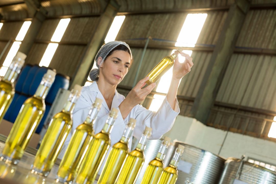 Technician examining olive oil - Free Images, Stock Photos and Pictures on Pikwizard.com