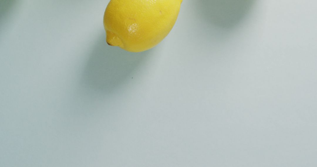 Single Fresh Lemon on Light Blue Background - Free Images, Stock Photos and Pictures on Pikwizard.com