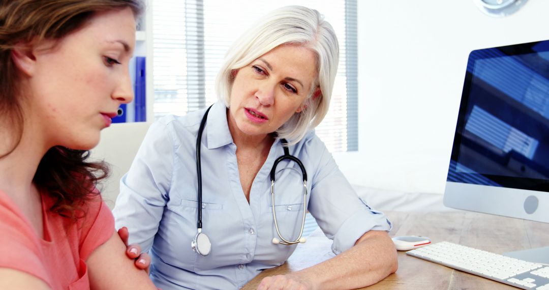 Concerned Female Doctor Consulting with Patient in Office - Free Images, Stock Photos and Pictures on Pikwizard.com