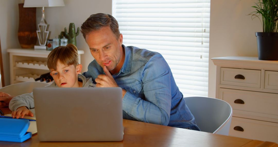 Father Helping Son with Homework on Laptop at Home - Free Images, Stock Photos and Pictures on Pikwizard.com