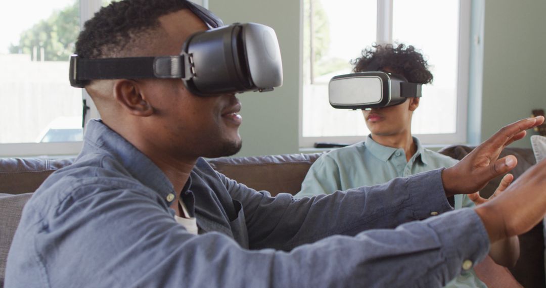 Two Young Men Experiencing Virtual Reality at Home - Free Images, Stock Photos and Pictures on Pikwizard.com