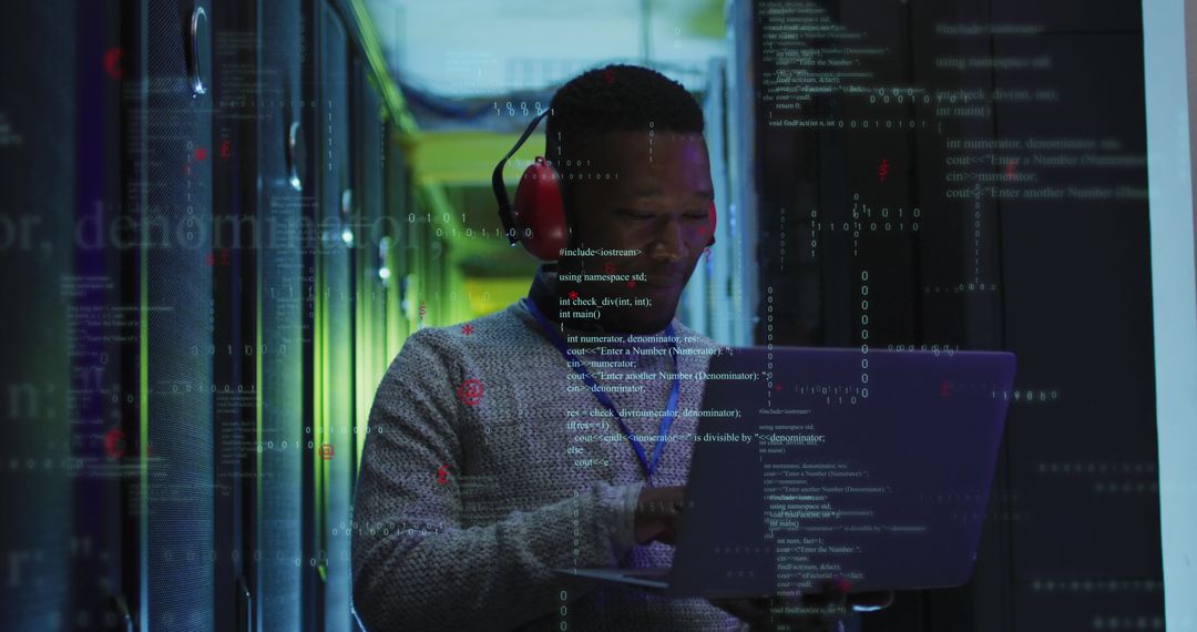 African American Engineer Analyzing Data in Server Room