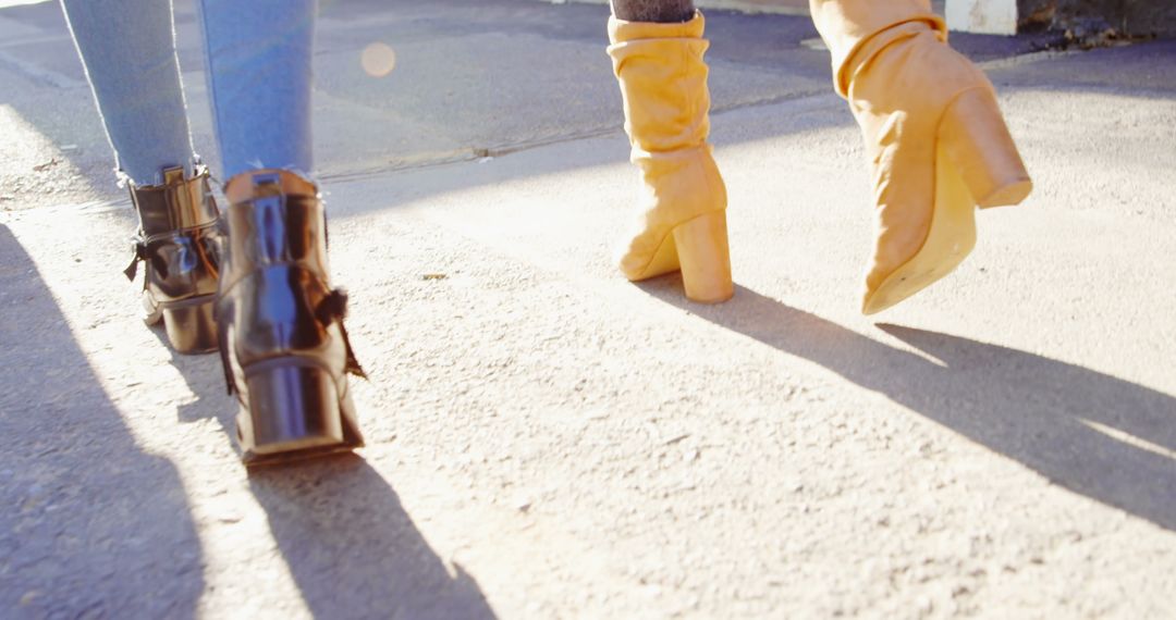 Stylish Women Walking Hand in Hand Under Sunlight