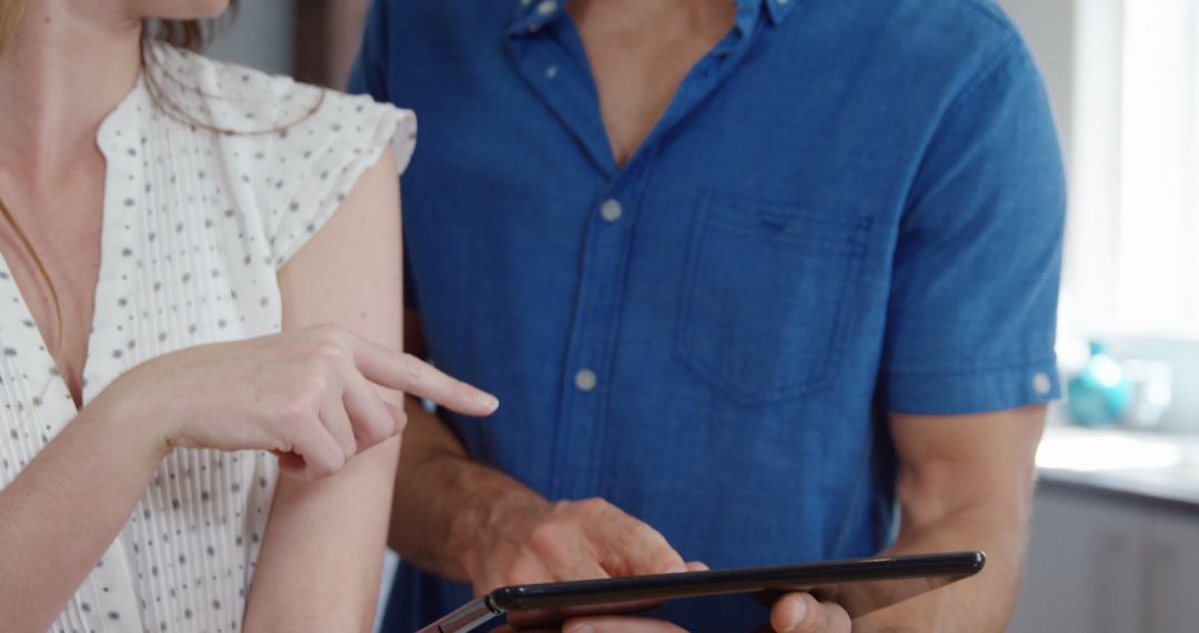Happy Couple Sharing Tablet in Modern Home