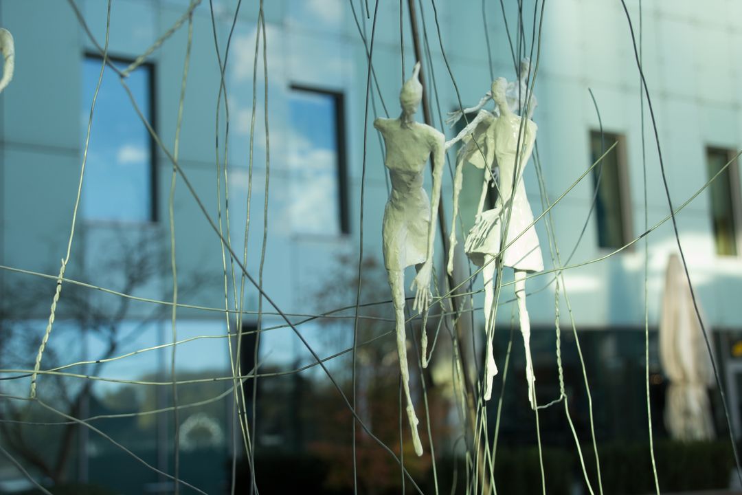 Abstract Art Installation With Sculpted Figures and Wire