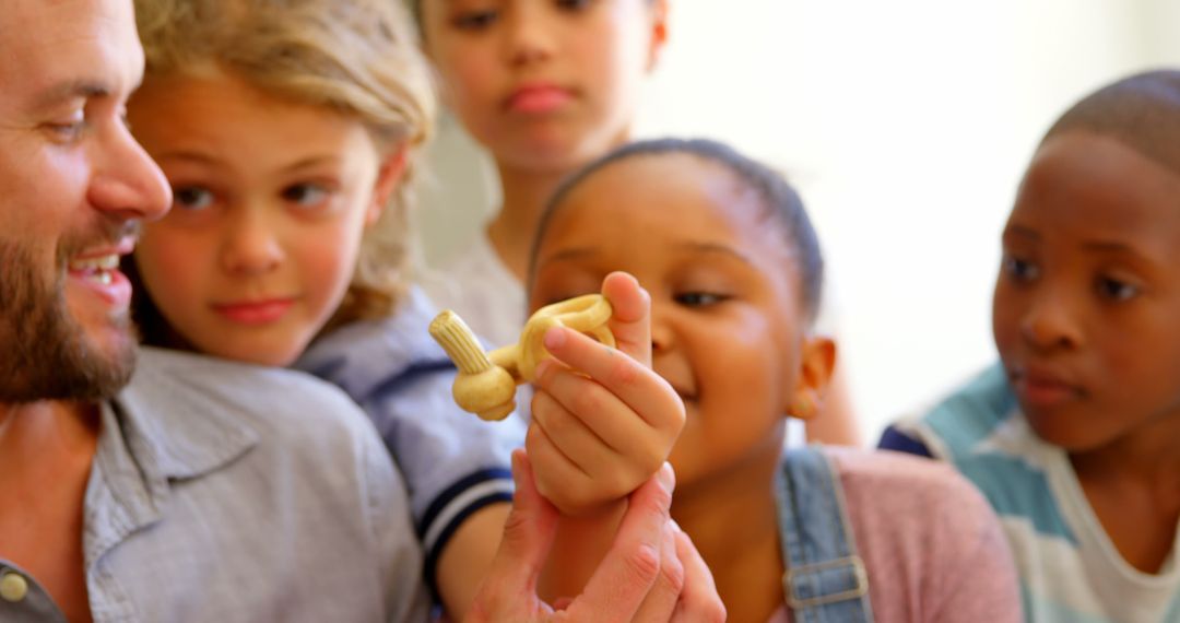 Diverse Children and Teacher Studying Anatomical Model in Classroom
