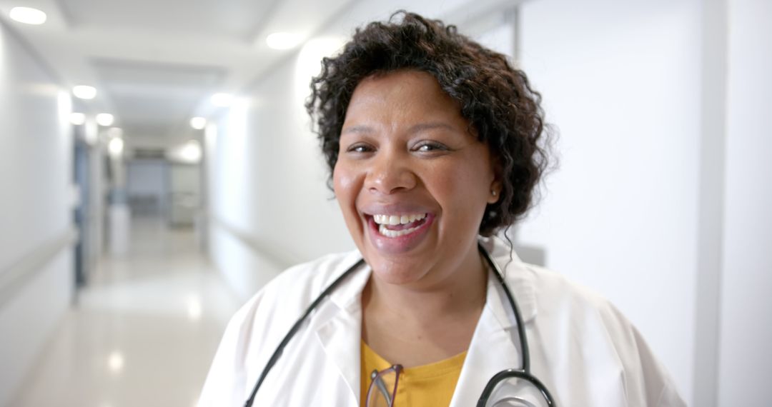 Smiling Female Doctor in a Hospital Corridor - Free Images, Stock Photos and Pictures on Pikwizard.com