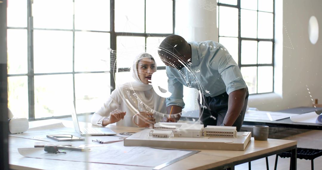 Architects Collaborating on Scale Model with Blueprints in Modern Studio