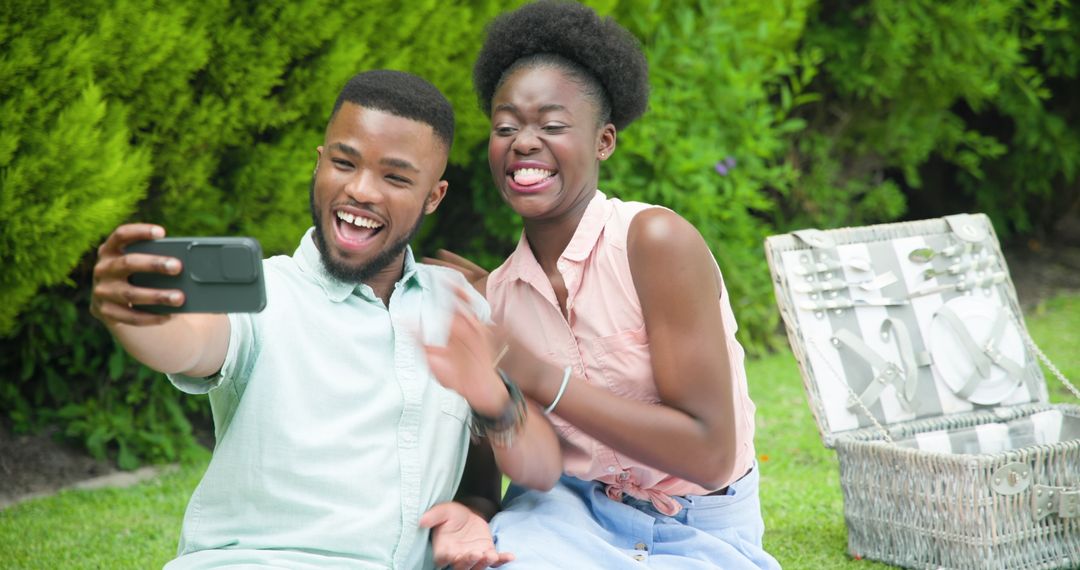 Joyful Couple Taking Selfie in Garden Surrounded by Nature