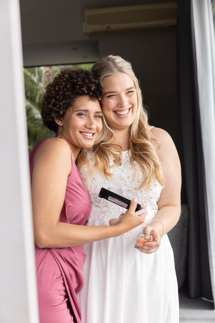 Bride and Bridesmaid Embracing in Elegant Dressing Room