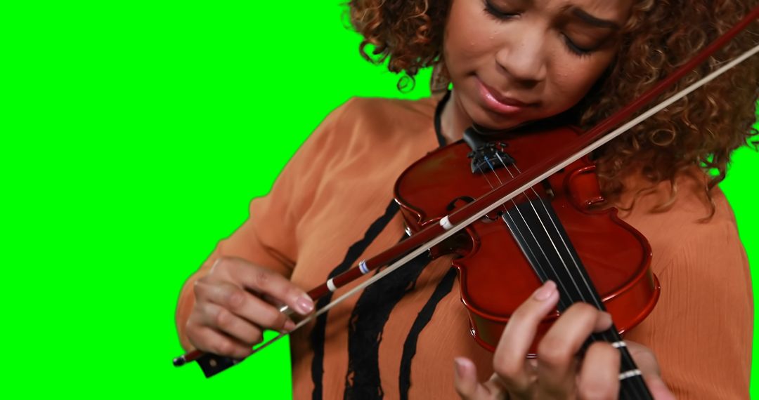 Focused Musician Playing Violin on Green Screen - Free Images, Stock Photos and Pictures on Pikwizard.com