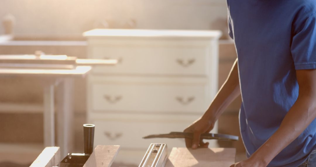 Craftsman Skillfully Using Track Saw in Sunlit Workshop