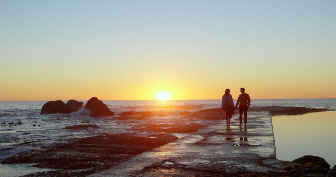 Romantic Couple Walking Along Beach At Sunset - Free Images, Stock Photos and Pictures on Pikwizard.com