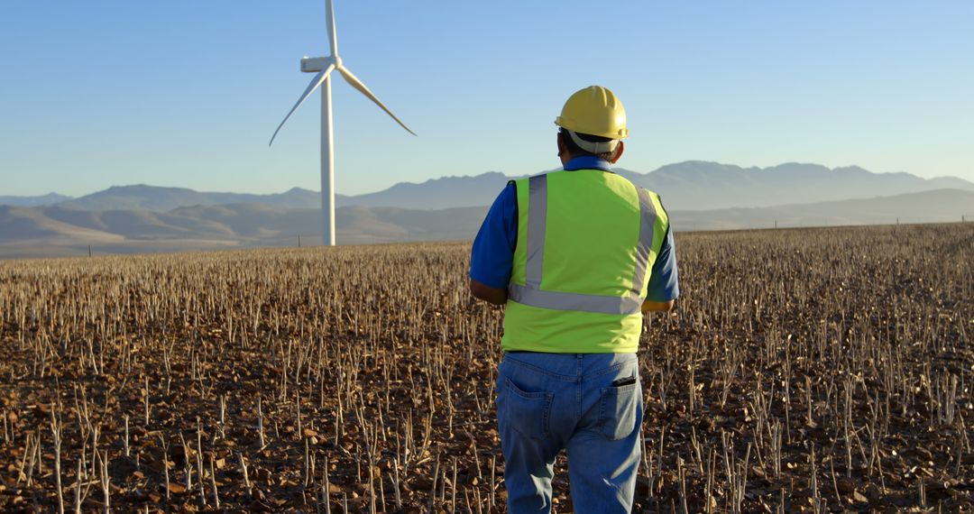 Engineer Inspecting Wind Turbine in Rural Field - Free Images, Stock Photos and Pictures on Pikwizard.com