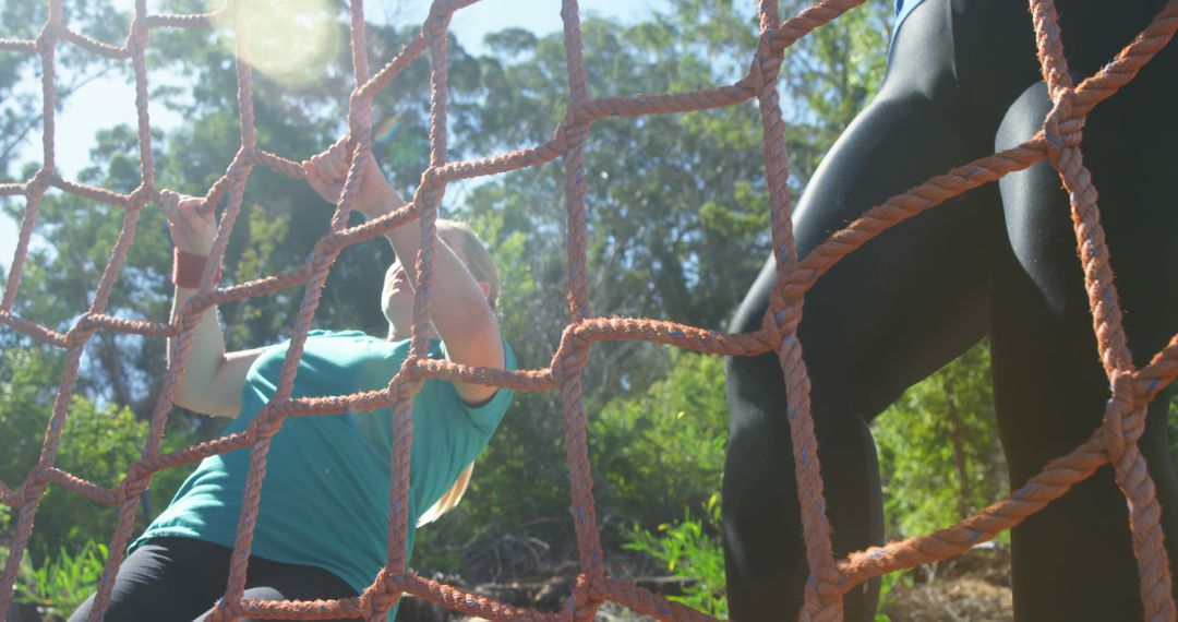 Woman Climbing Net on Outdoor Obstacle Course - Free Images, Stock Photos and Pictures on Pikwizard.com