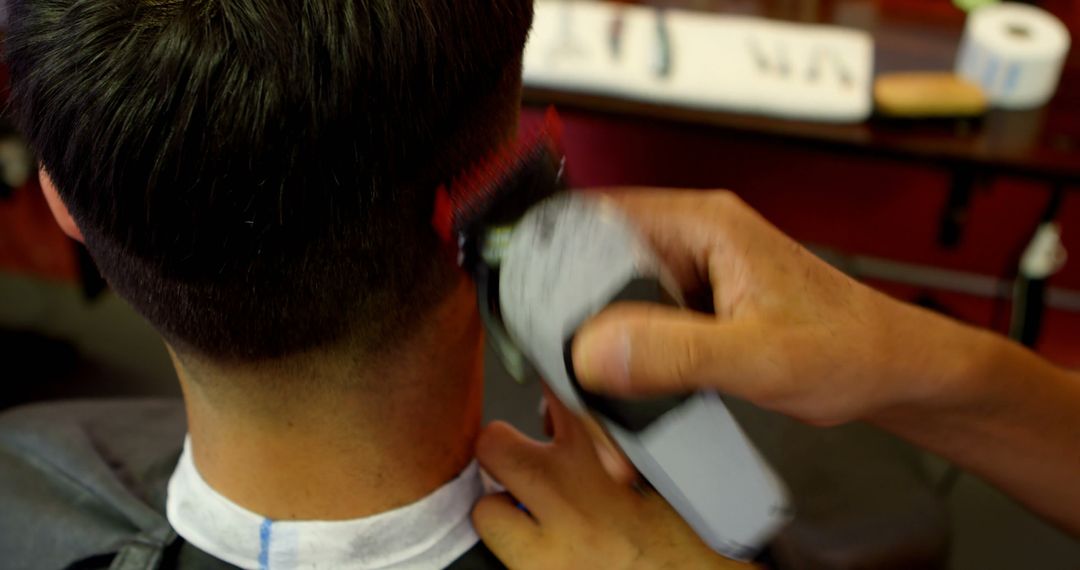 Barber Using Clippers on Client's Hair in Barbershop - Free Images, Stock Photos and Pictures on Pikwizard.com