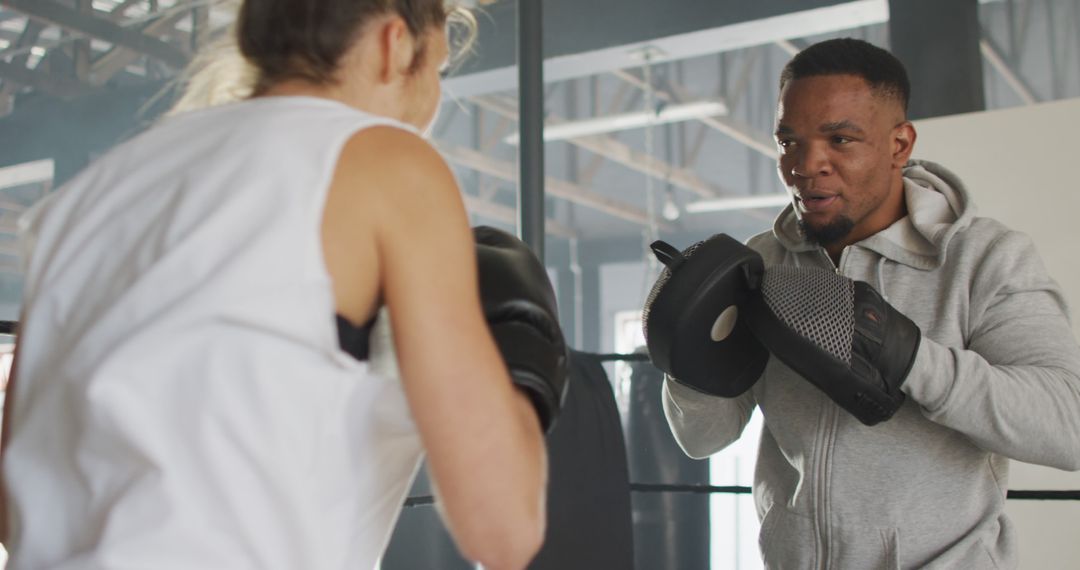 Boxing Trainer Instructing Female Athlete in Gym - Free Images, Stock Photos and Pictures on Pikwizard.com